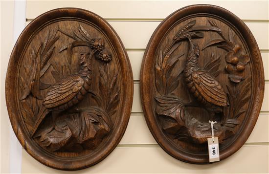 A pair of oval carved plaques, H.50cm